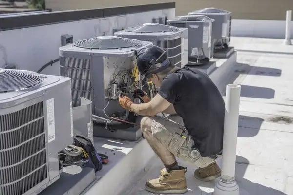 depositphotos_289898966-stock-photo-hvac-technician-checking-controls-on